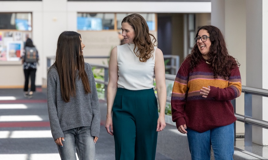 Alex Sturm walking with students in University Hall