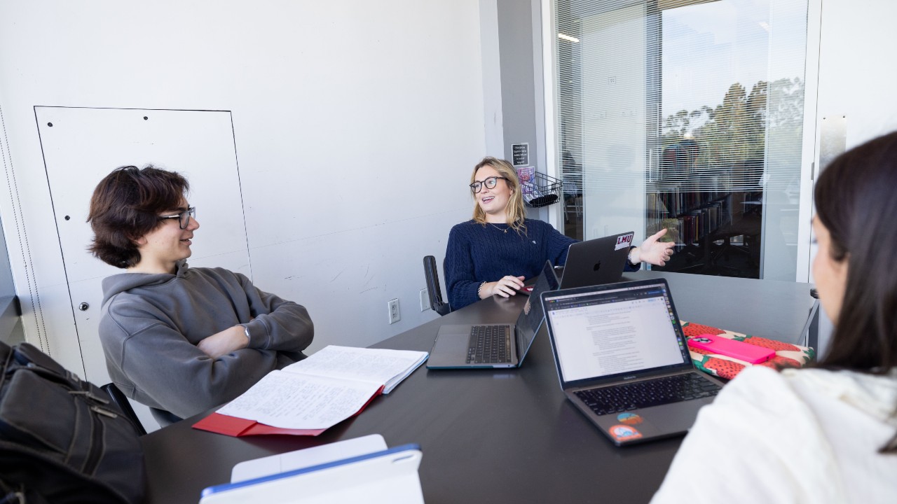Students working on laptops in study room