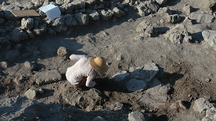 A student working at an archeological excavation site