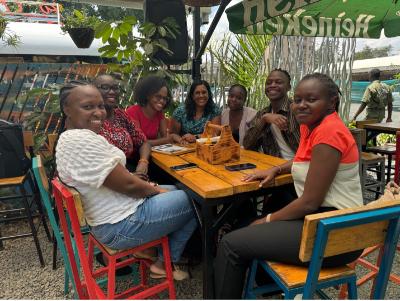 Prachi Jain and Busara Lab staff around the table