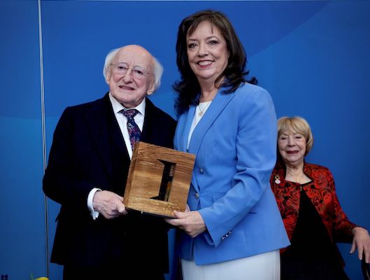 Mary O'Neill receiving award from Irish President