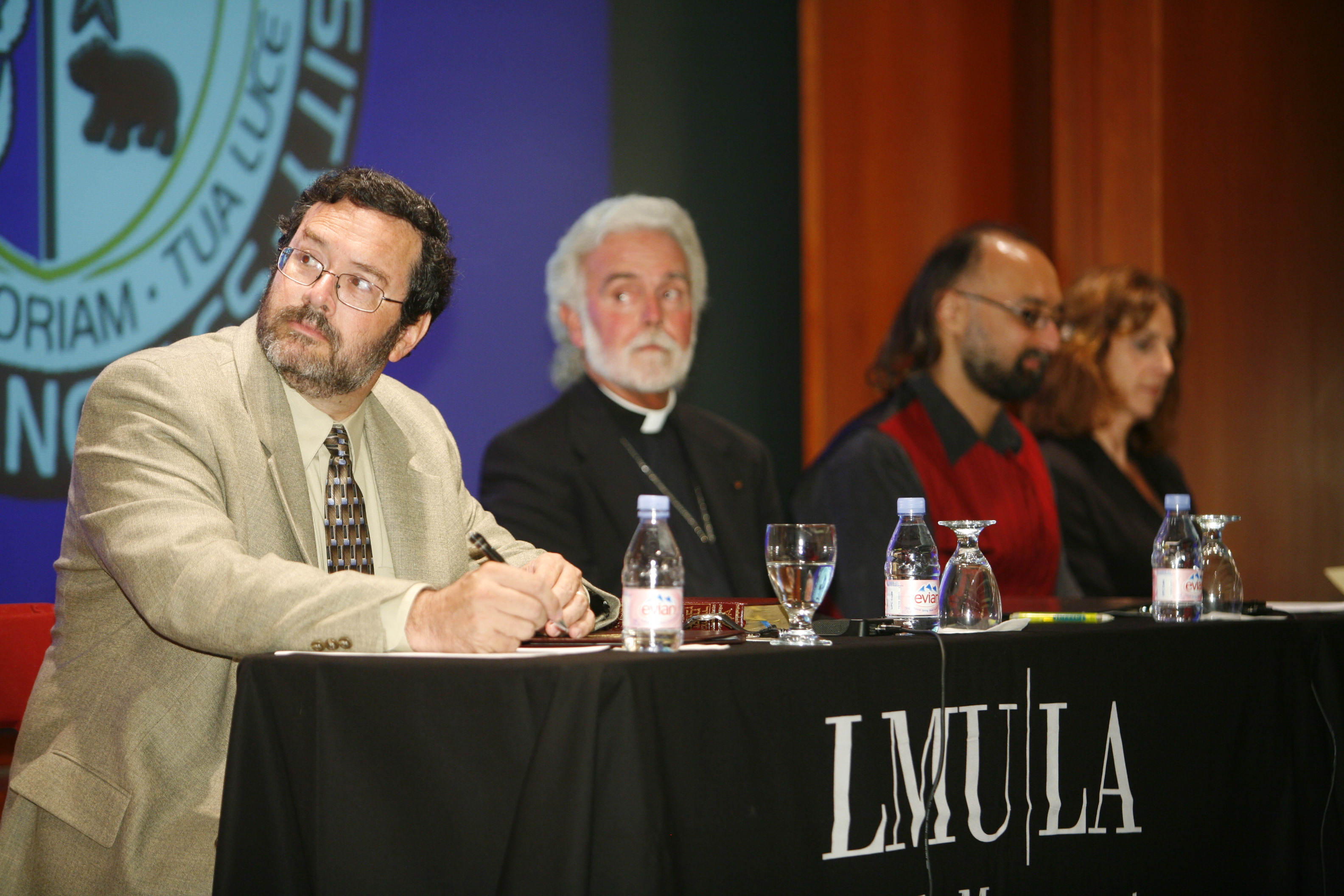 Panel of speakers sitting at table