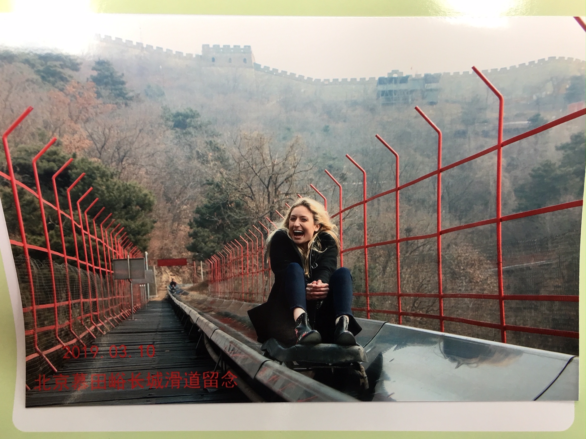 Student goes down slide in China. 