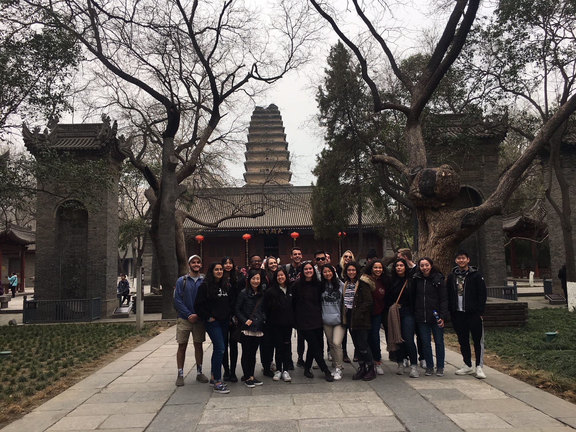 China Immersion Students in front of a large, old-looking tower. 