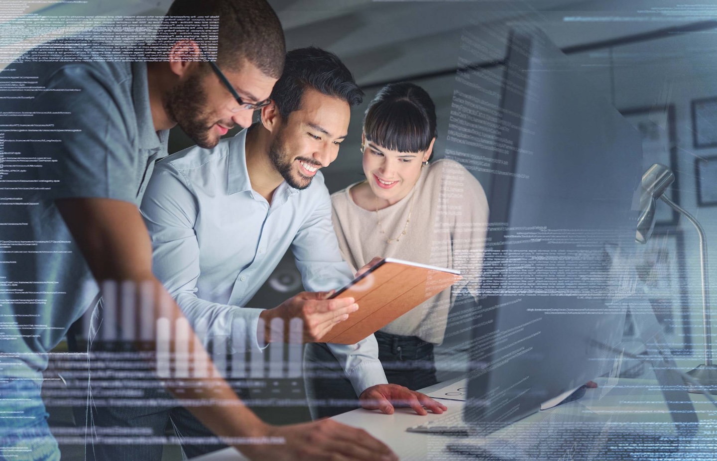 Two men and a woman looking at data on computer screen
