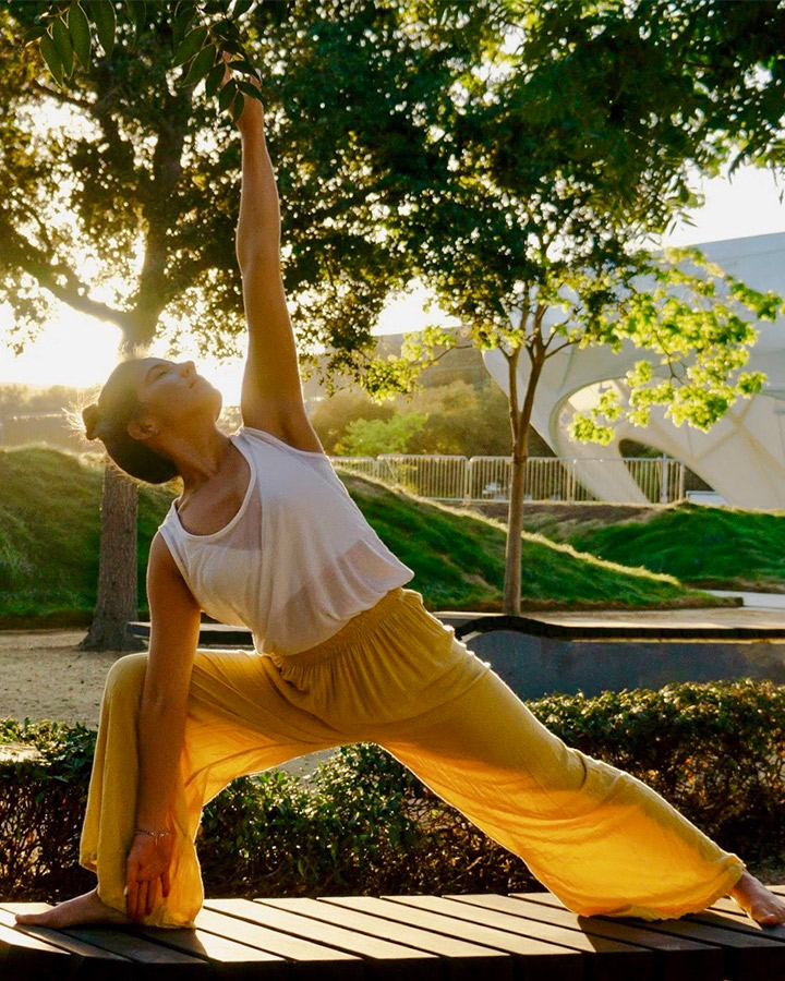 LMU Yoga Studies Alum Lizbeth Vásquez doing yoga outside