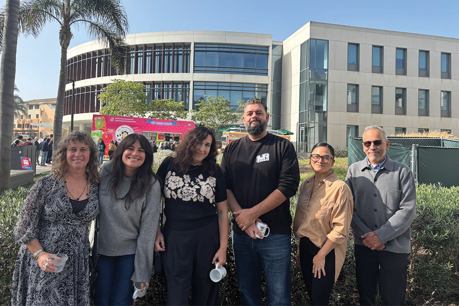 Evelyn McDonnell with (Every Day Is) Taco Tuesday panelists (from left to right): McDonnell, Brittny Mejia (Los Angeles Times), Mandalit del Barco (NPR), Memo Torres (L.A. TACO), Yanira Lemus (Loyola Immigration Law Clinic), and Rubén Martínez (LMU) outside with Taco Trucks in the background.