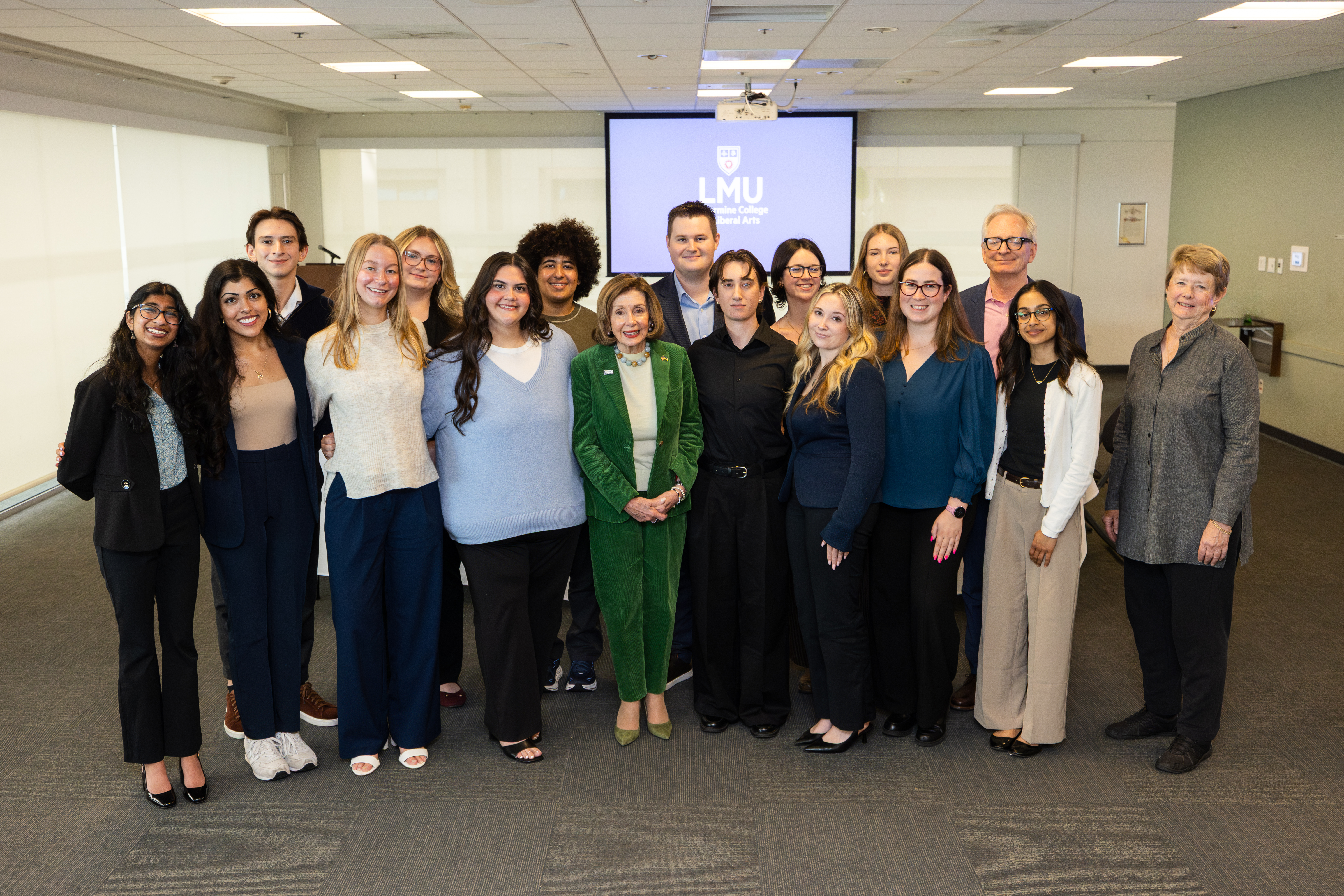 Nancy Pelosi in the center of a group photo with BCLA student advisory board members and some faculty