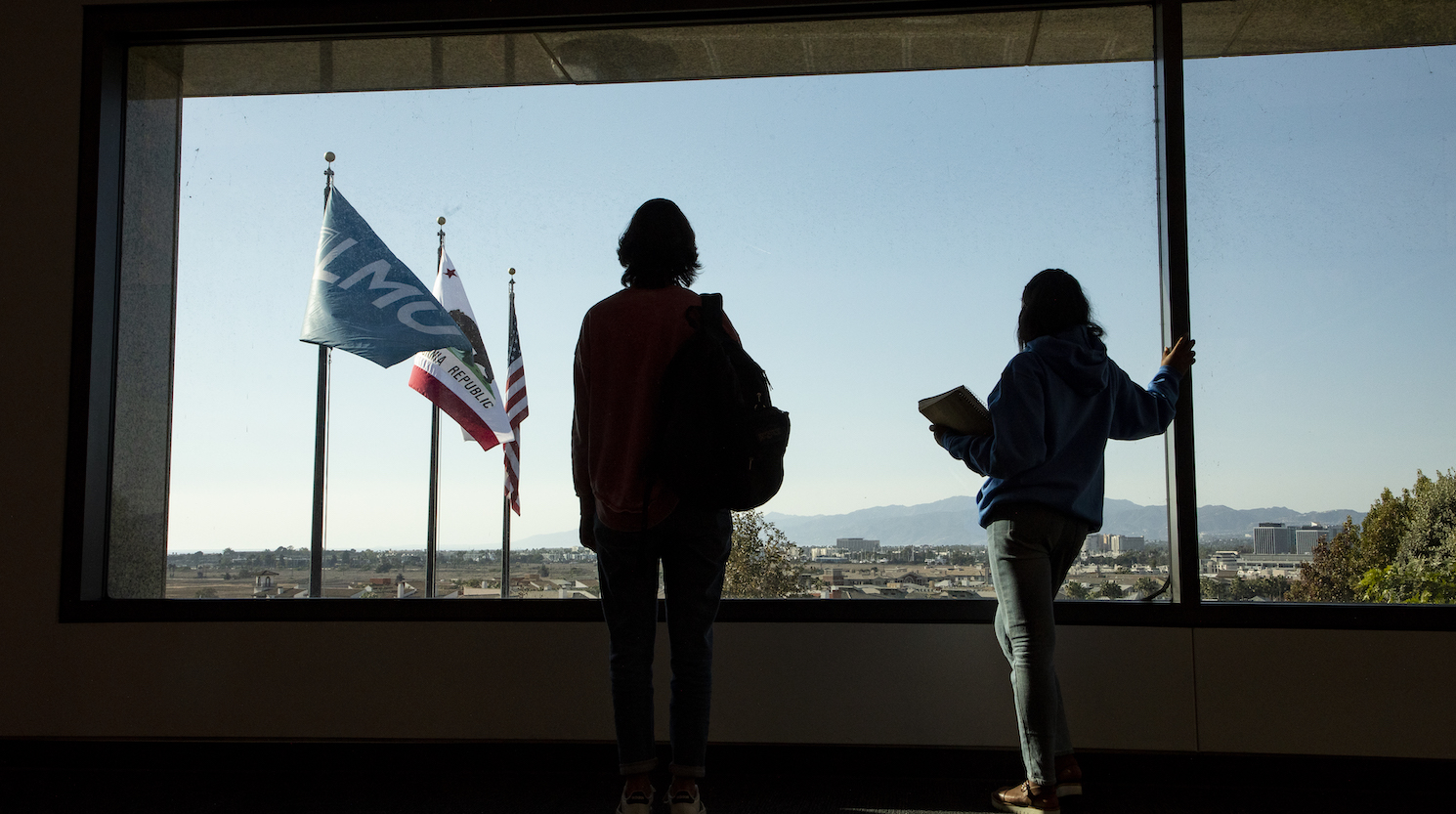 Two students gazing out at Los Angeles in University Hall