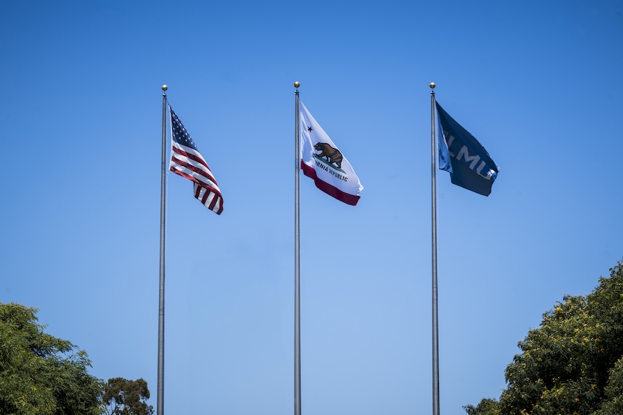 US Flag, California Flag, and LMU Flag on flagpoles