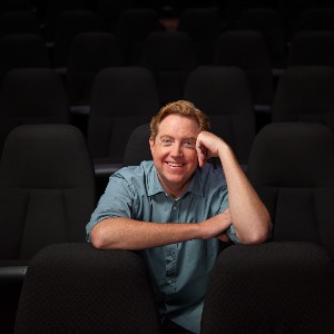 Kelly Younger smiling seated in theater