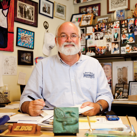 Photo of Gregory Boyle, S.J. sitting at his desk