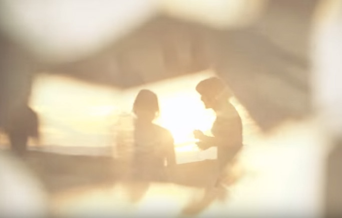 Two people off in the sunset with lens flares 