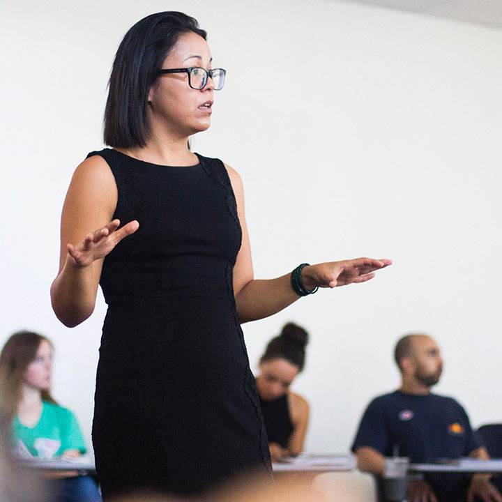 A faculty member speaking to a classroom during a lecture