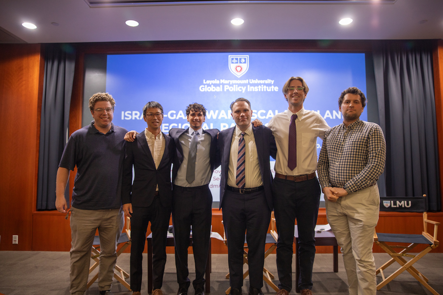 Professor and student moderators with a Speaker