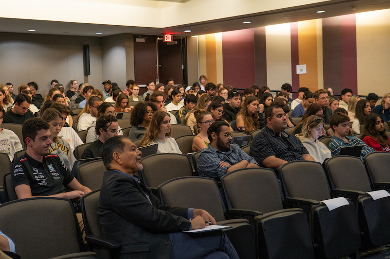 A professor and students listening to Brooks