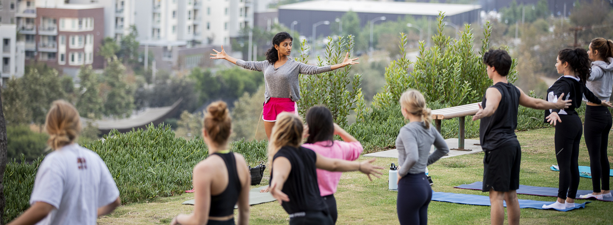 Yoga teacher leading students in practice